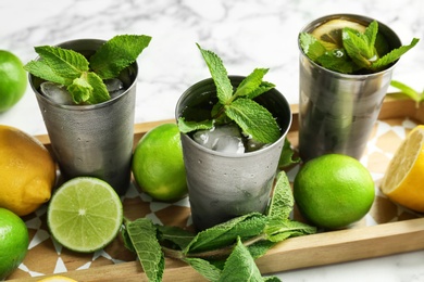 Photo of Composition with delicious mint julep cocktail on table