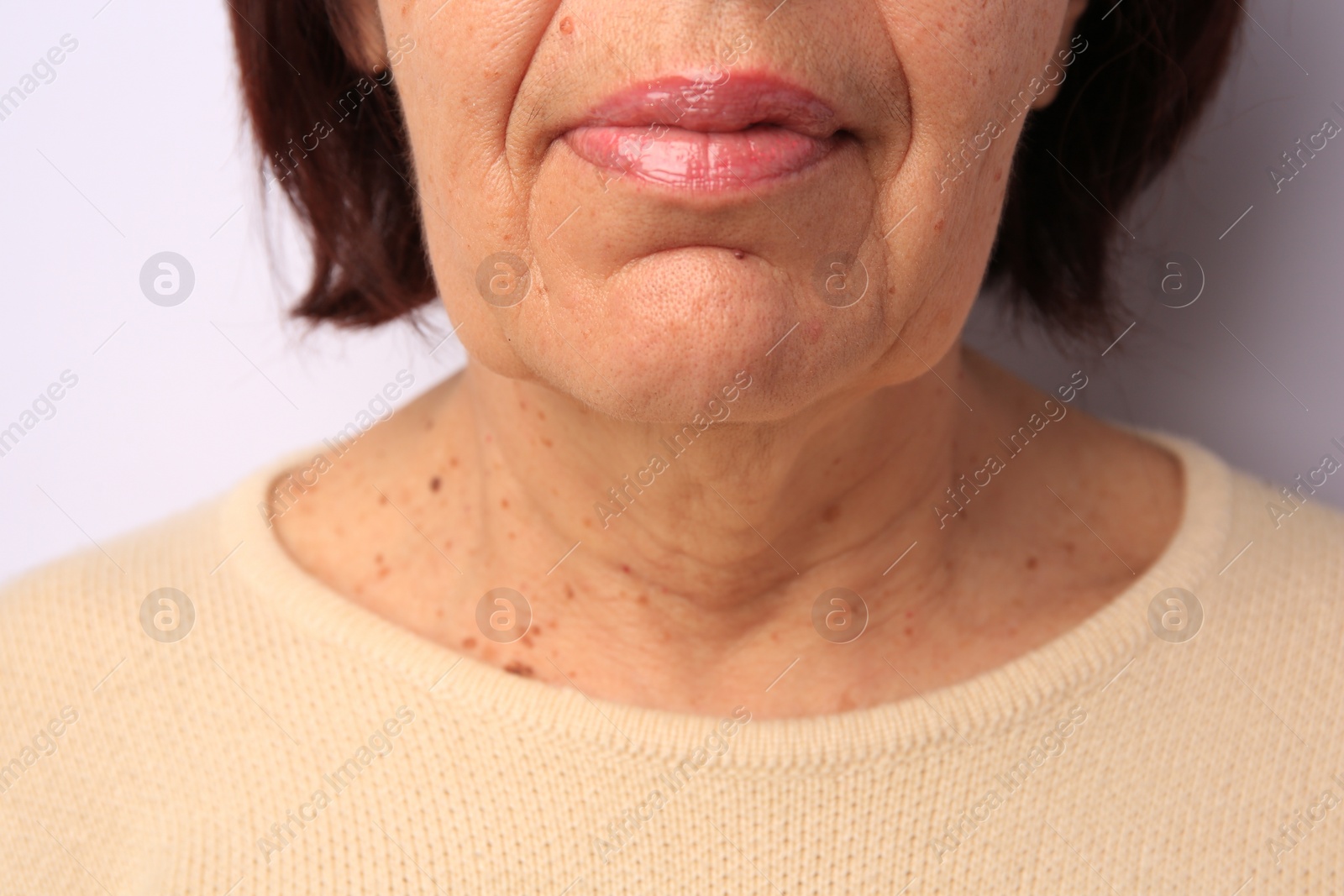 Photo of Closeup view of older woman on white background