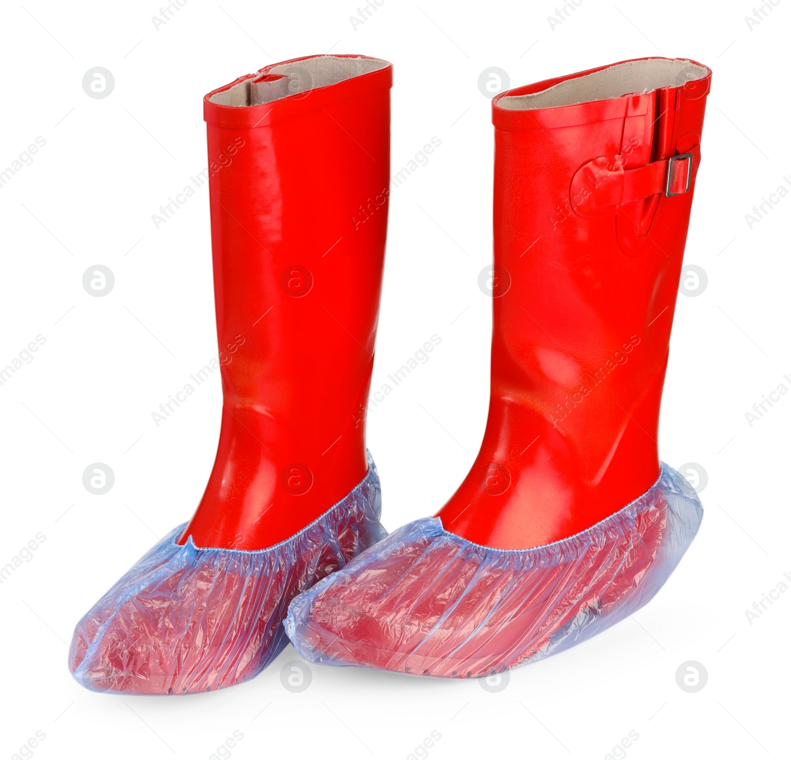 Photo of Rubber boots in blue shoe covers isolated on white