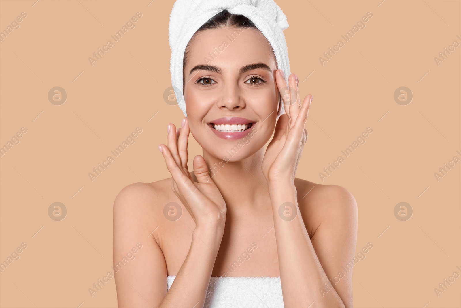 Photo of Young woman in towels on beige background. Spa treatment