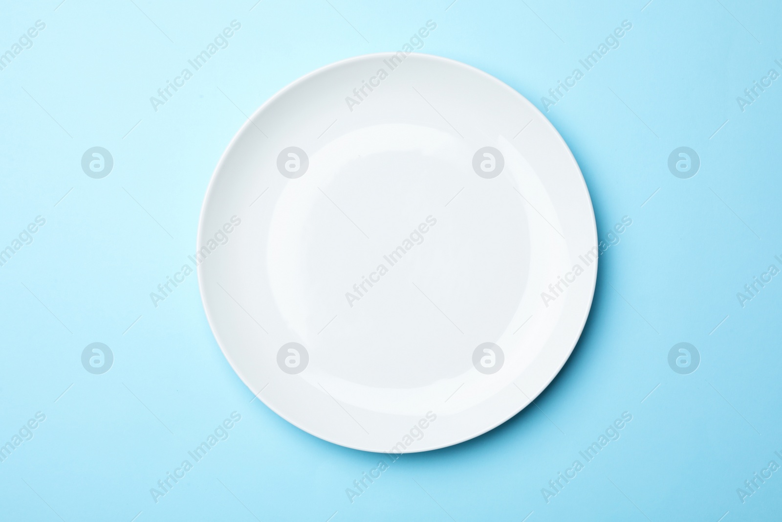 Photo of Stylish ceramic plate on color background, top view