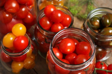 Photo of Pickling jars with fresh tomatoes, closeup view