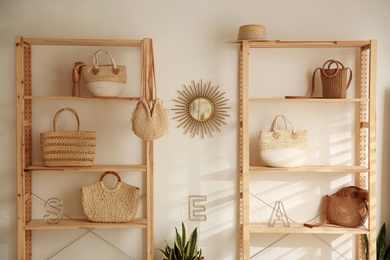 Stylish woman's bags on shelves in boutique