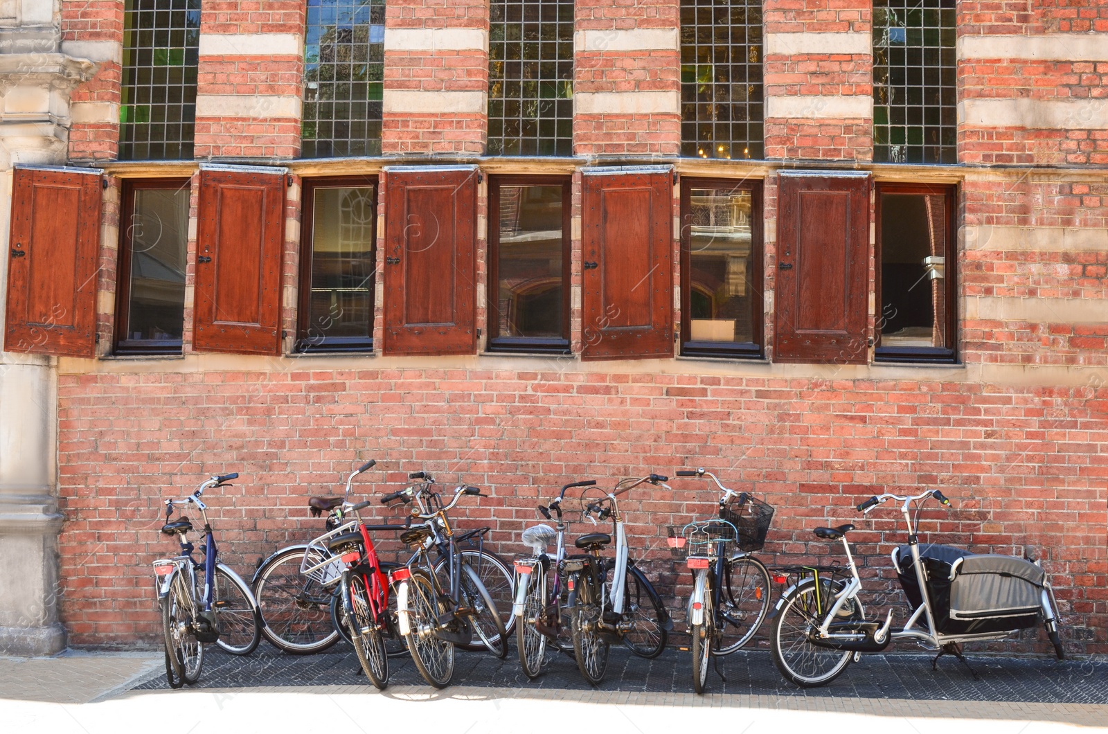 Photo of Parked bicycles near old building on city street