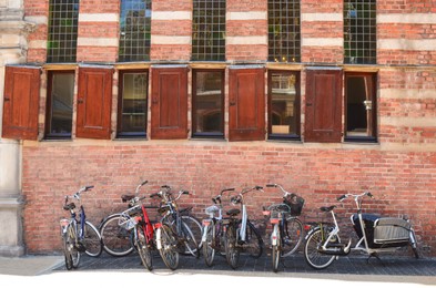 Parked bicycles near old building on city street