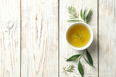 Photo of Flat lay composition with fresh olive oil on wooden background