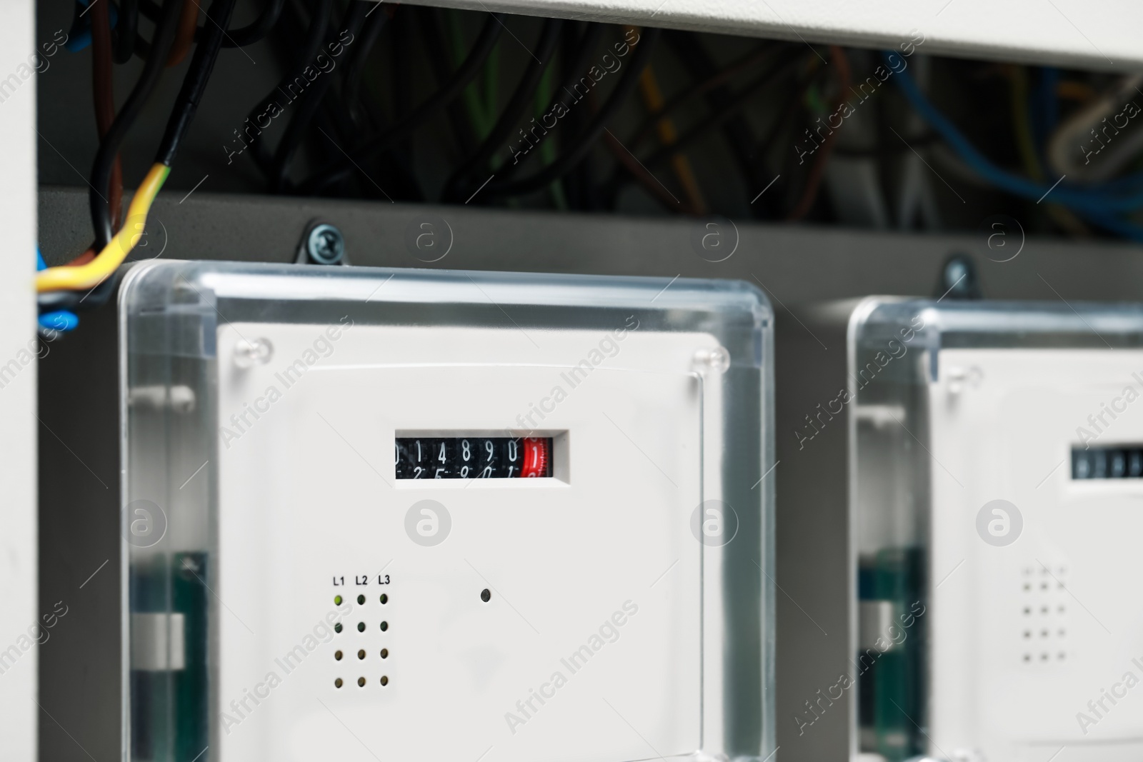 Photo of Electric meters and wires in fuse box, closeup