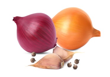 Different onion bulbs, garlic cloves and pepper on white background