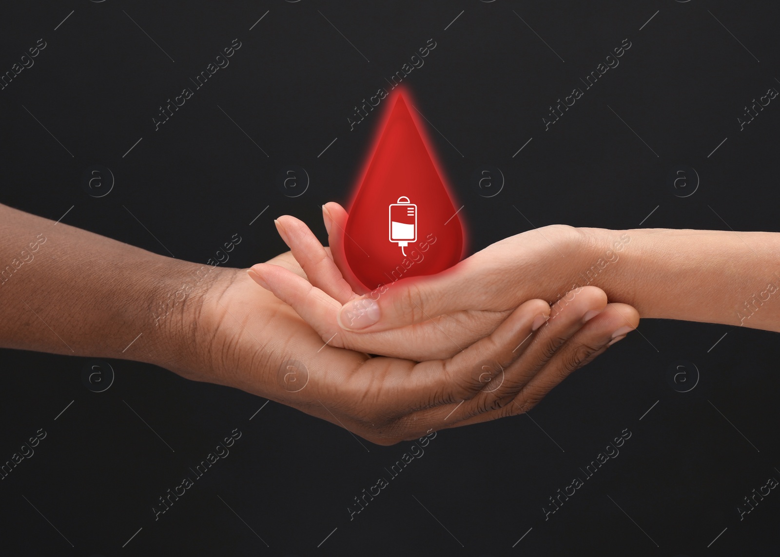 Image of People holding red drop in hands on dark background, closeup. Blood donation concept