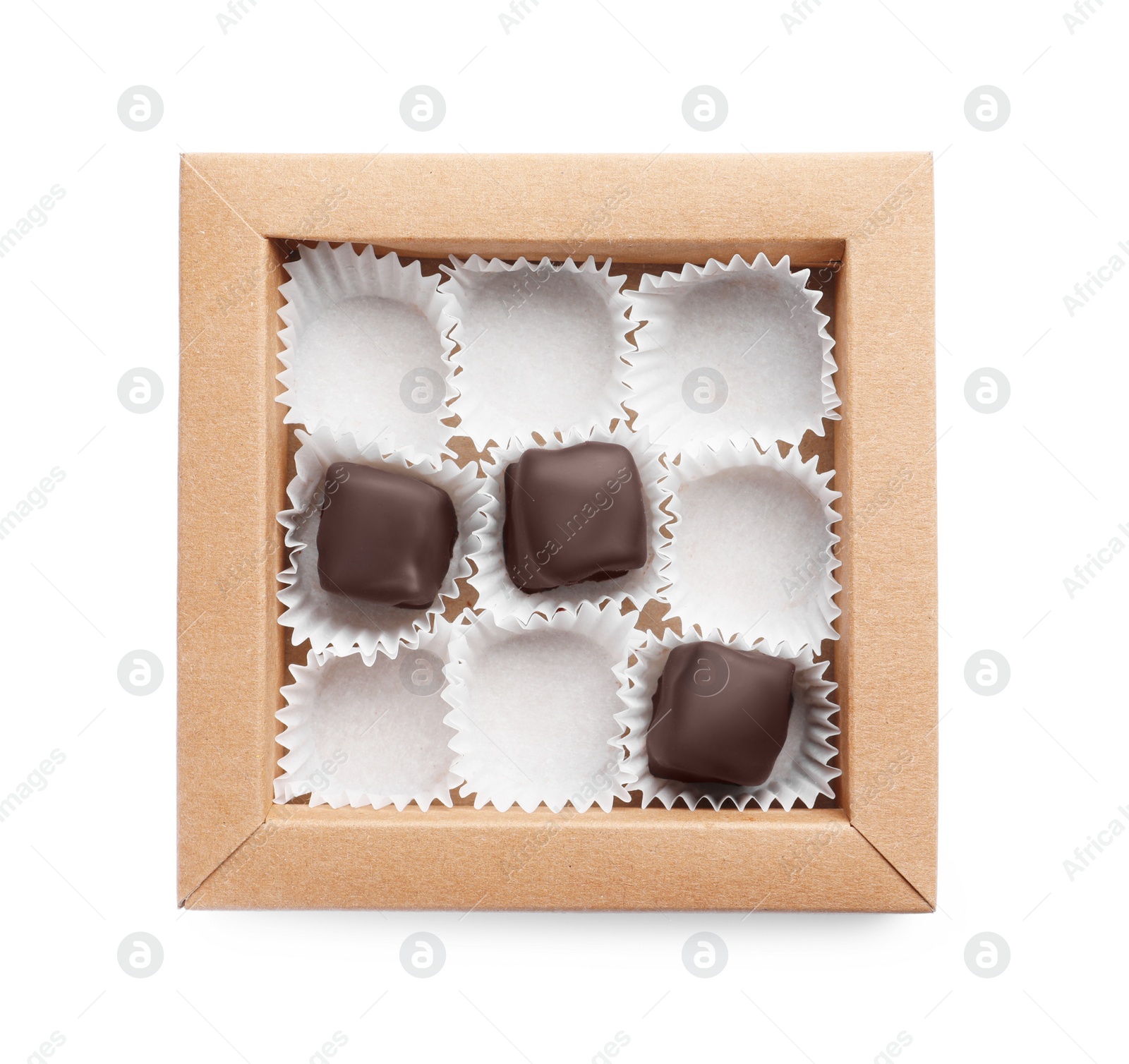 Photo of Partially empty box of chocolate candies isolated on white, top view