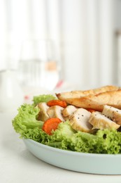 Tasty cooked chicken fillet with fresh salad served on white table in kitchen. Healthy meals from air fryer
