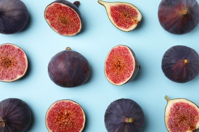 Photo of Fresh ripe purple figs on light blue background, flat lay