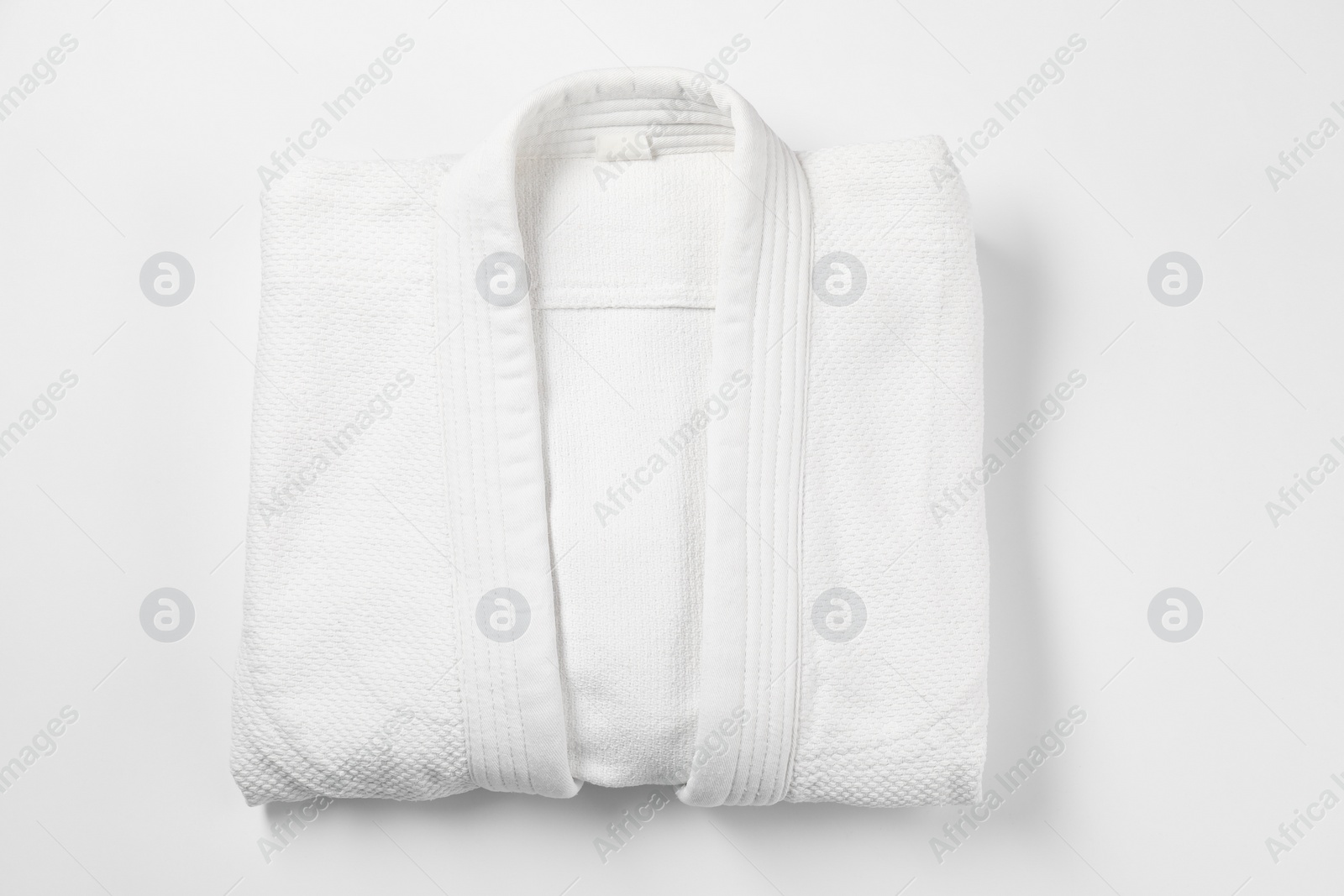 Photo of Kimono on white background, top view. Martial arts uniform