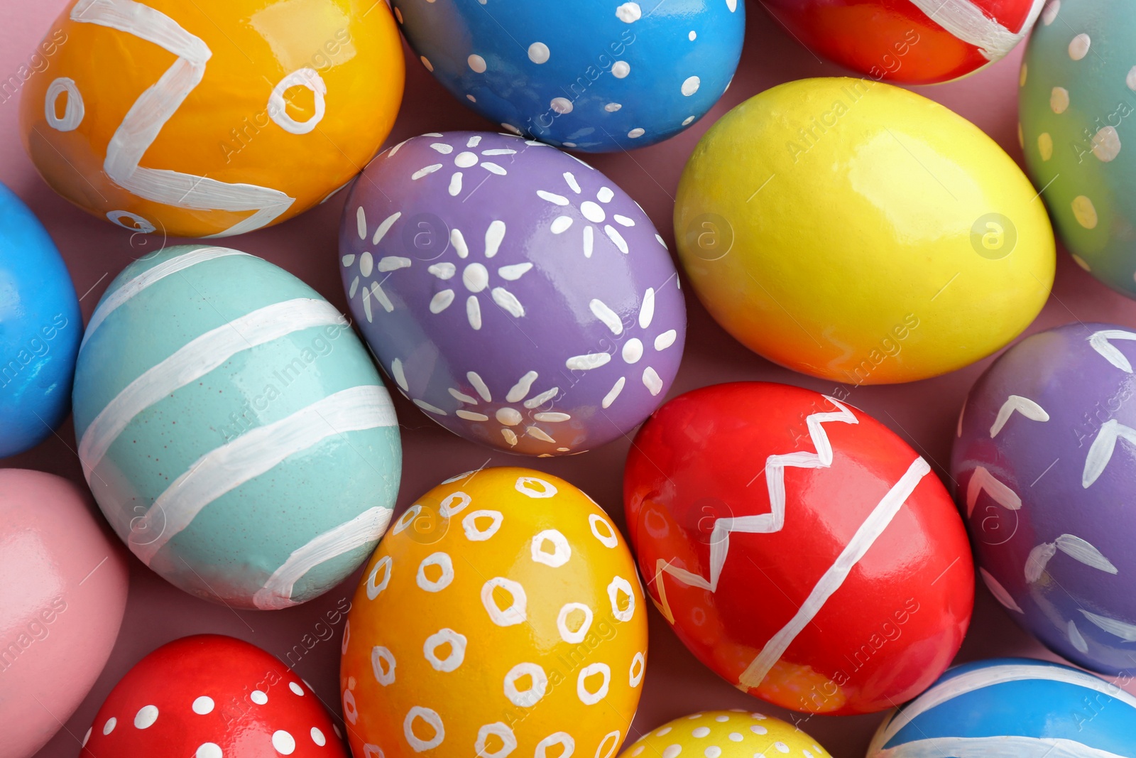 Photo of Many colorful painted Easter eggs as background, top view