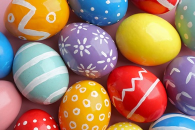 Photo of Many colorful painted Easter eggs as background, top view