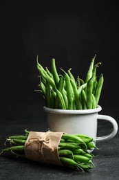 Photo of Delicious fresh green beans on black table