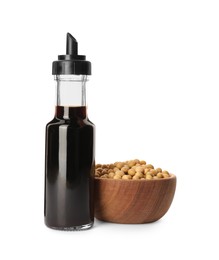 Photo of Bottle of soy sauce and soybeans in wooden bowl isolated on white