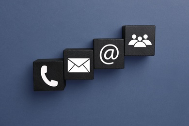 Image of Hotline service. Black cubes with icons on dark background, flat lay
