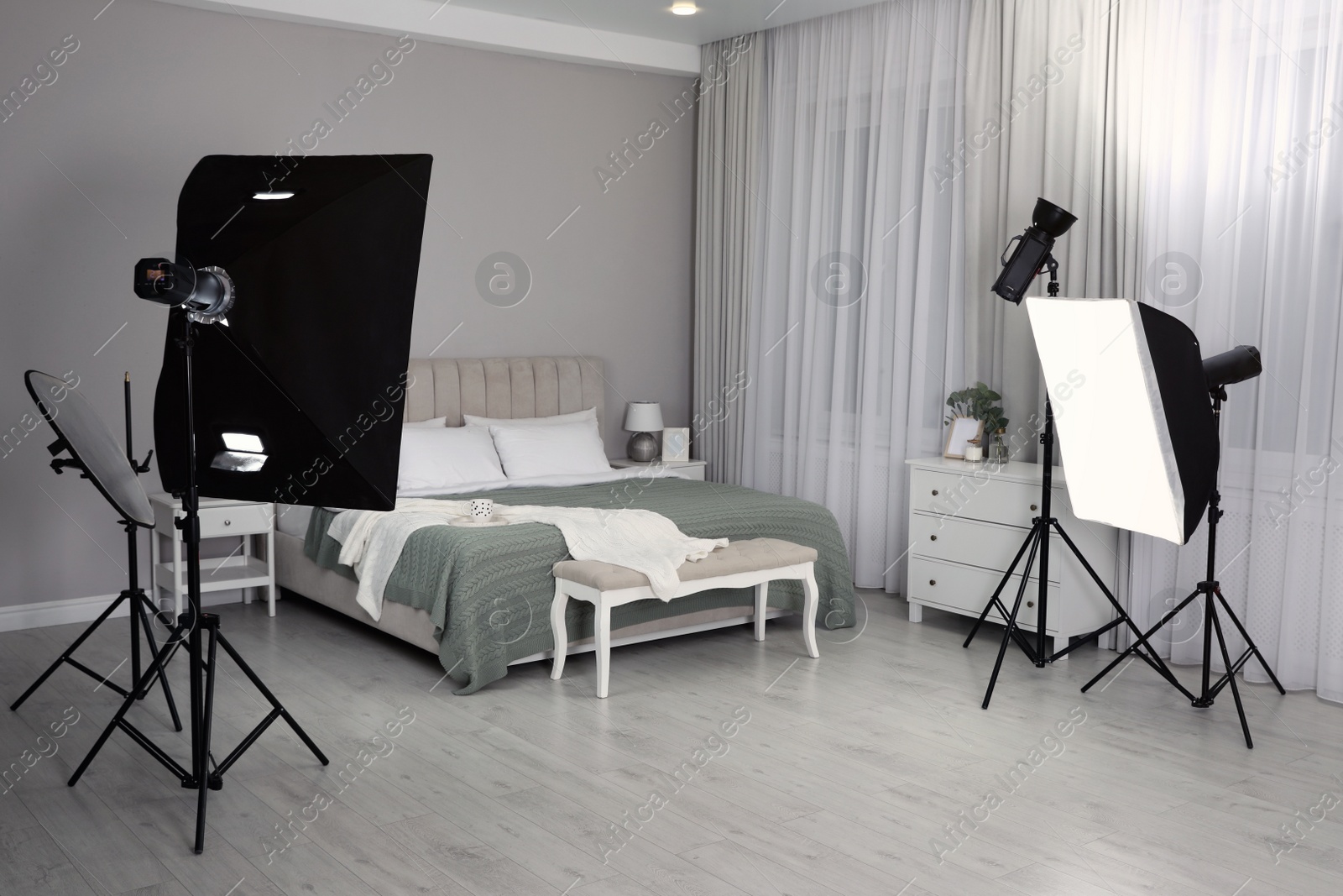 Photo of Professional photo studio equipment prepared for shooting bedroom interior