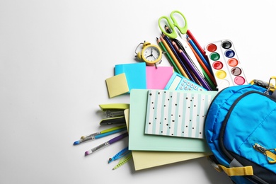 Backpack and school stationery on white background, flat lay with space for text. Back to school