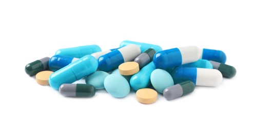 Heap of different colorful pills isolated on white