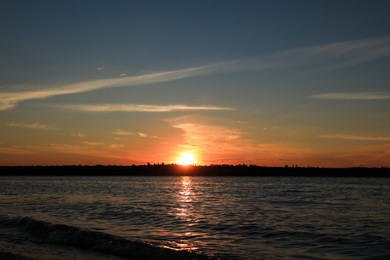 Landscape with beautiful sunset over calm river