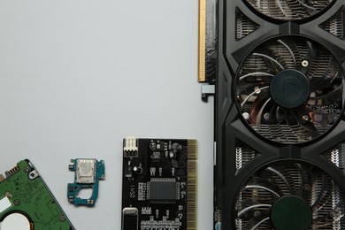 Photo of Graphics card and other computer hardware on light background, flat lay. Space for text