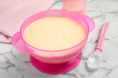 Photo of Healthy baby food served on white marble table