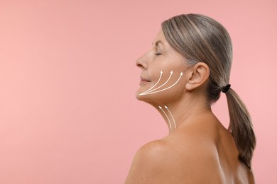 Image of Woman with perfect skin after cosmetic treatment on pink background, space for text. Lifting arrows on her neck and face