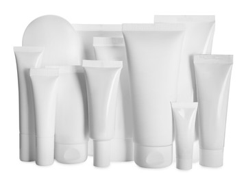 Blank tubes and jars of cosmetic products on white background