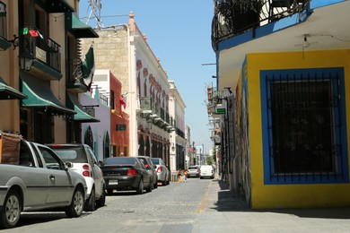 MONTERREY (NUEVO LEON), MEXICO - SEPTEMBER 29, 2022: Beautiful view of city street with parked cars on sunny day