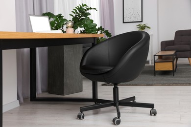 Comfortable office chair near desk in modern workplace
