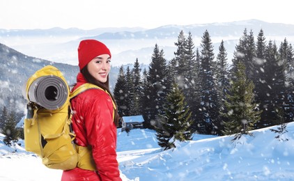 Image of Happy tourist with backpack in snowy mountains