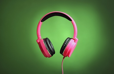 Photo of Stylish headphones with pads on color background