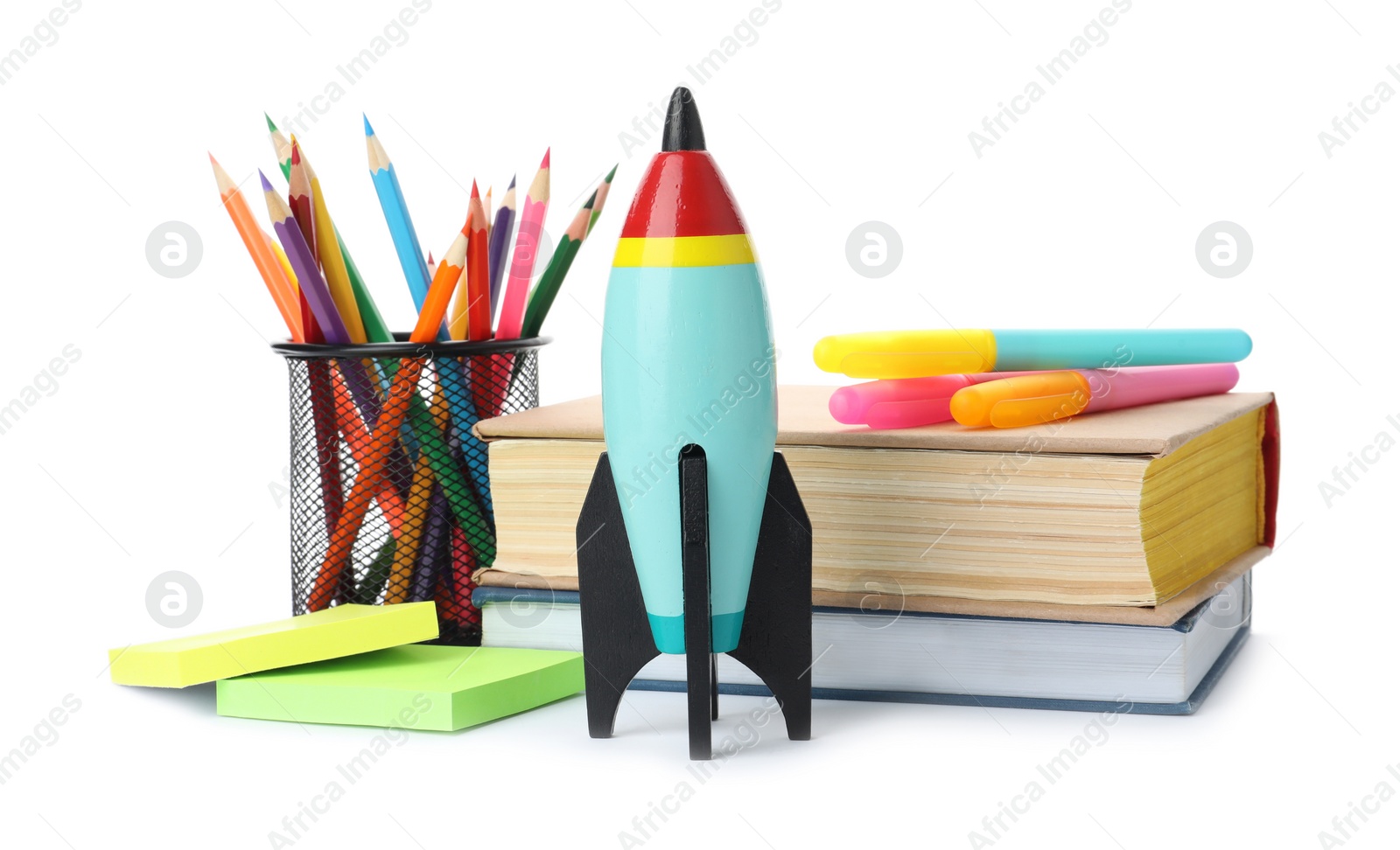 Photo of Bright toy rockets and school supplies on white background