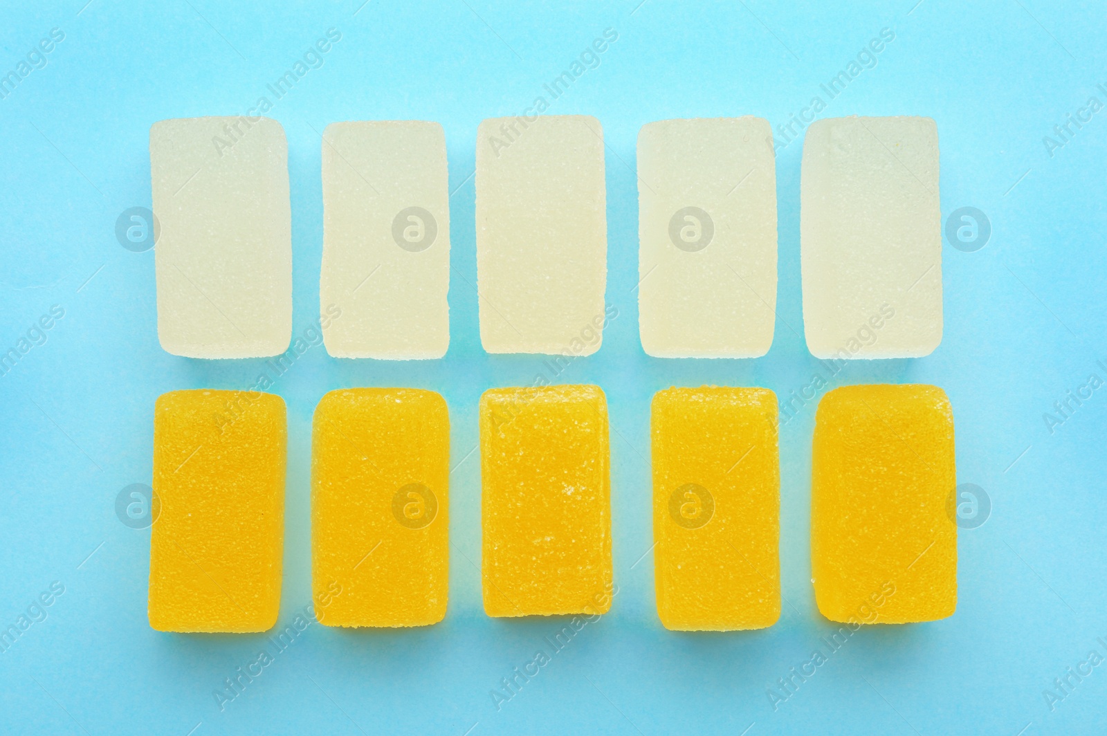 Photo of Tasty jelly candies on color background, flat lay