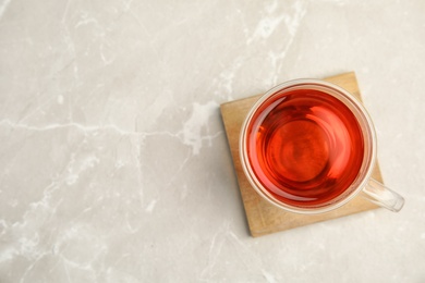 Glass cup of black tea on table, top view