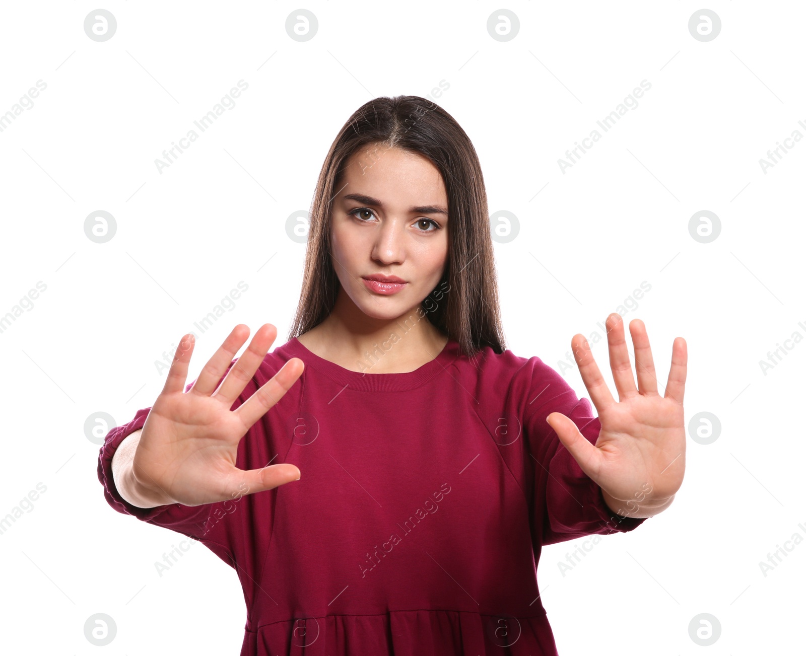 Photo of Woman showing STOP gesture in sign language on white background