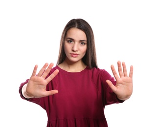 Woman showing STOP gesture in sign language on white background