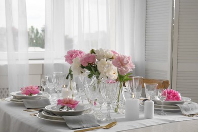 Photo of Stylish table setting with beautiful peonies in dining room