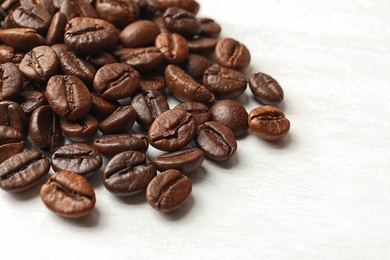 Photo of Roasted coffee beans on white background, closeup