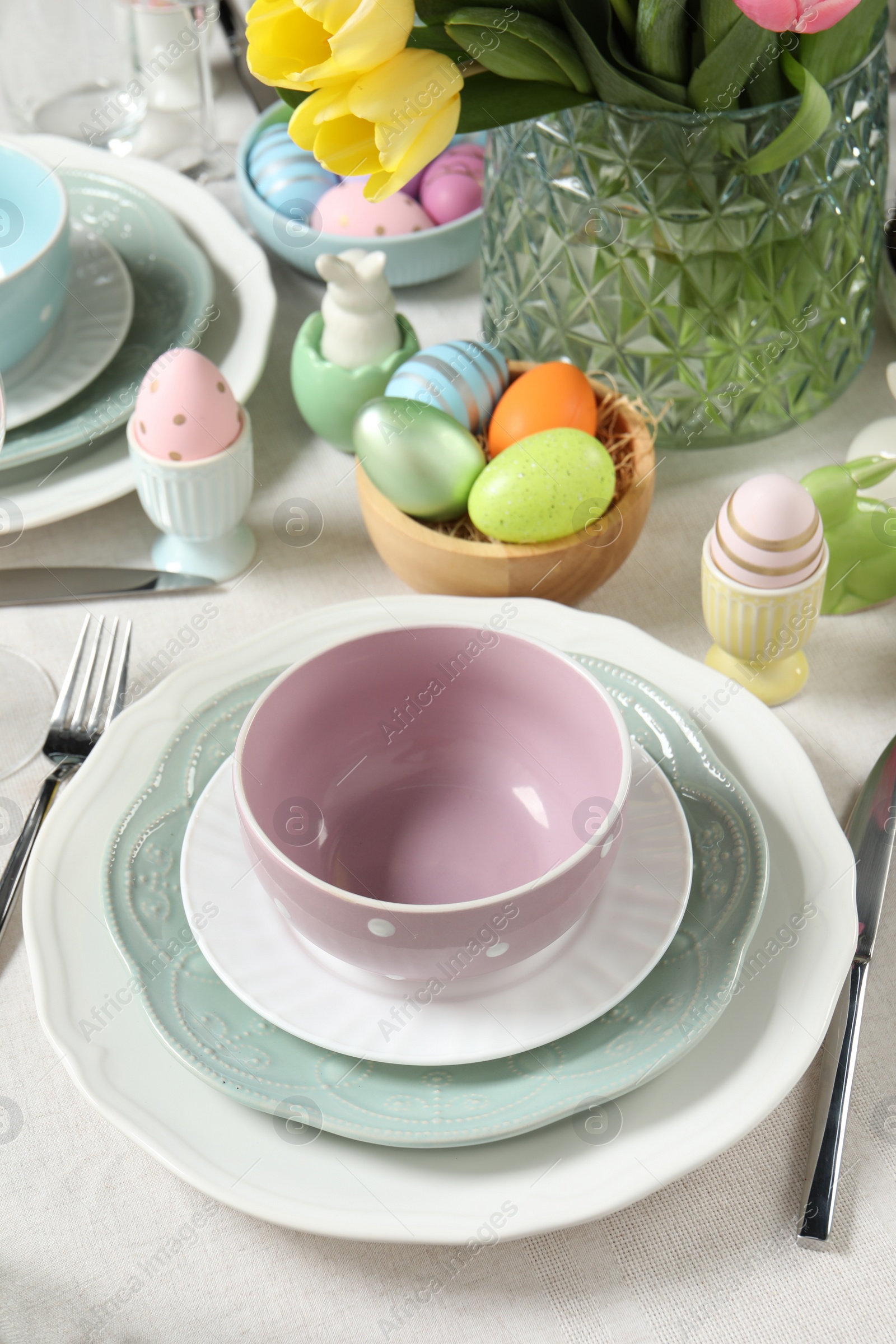 Photo of Easter celebration. Festive table setting with painted eggs.