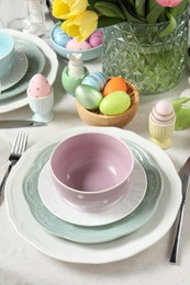 Easter celebration. Festive table setting with painted eggs.