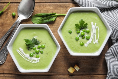 Photo of Fresh vegetable detox soup made of green peas served on table, top view