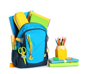 Backpack with school stationery on white background