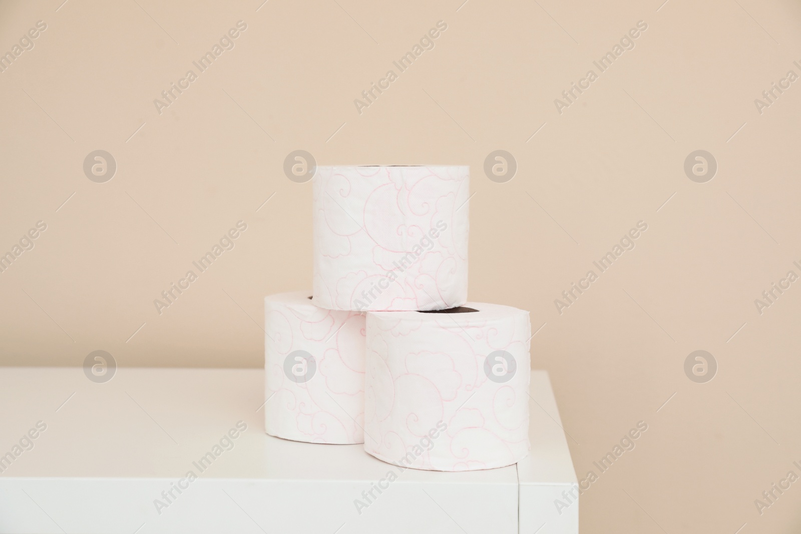 Photo of Toilet paper rolls on cabinet in bathroom