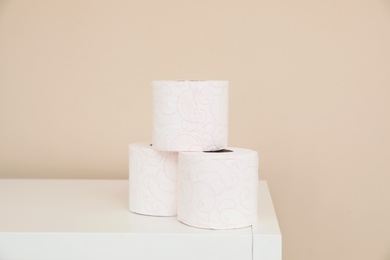 Toilet paper rolls on cabinet in bathroom