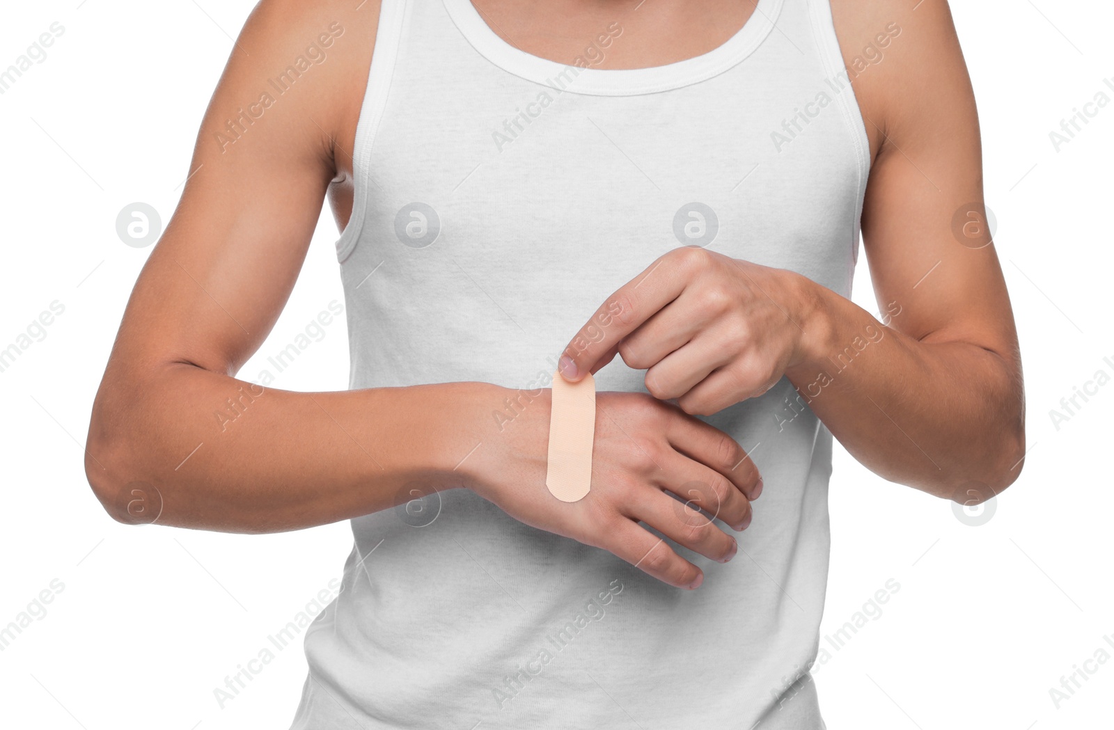 Photo of Man putting sticking plaster onto hand on white background, closeup