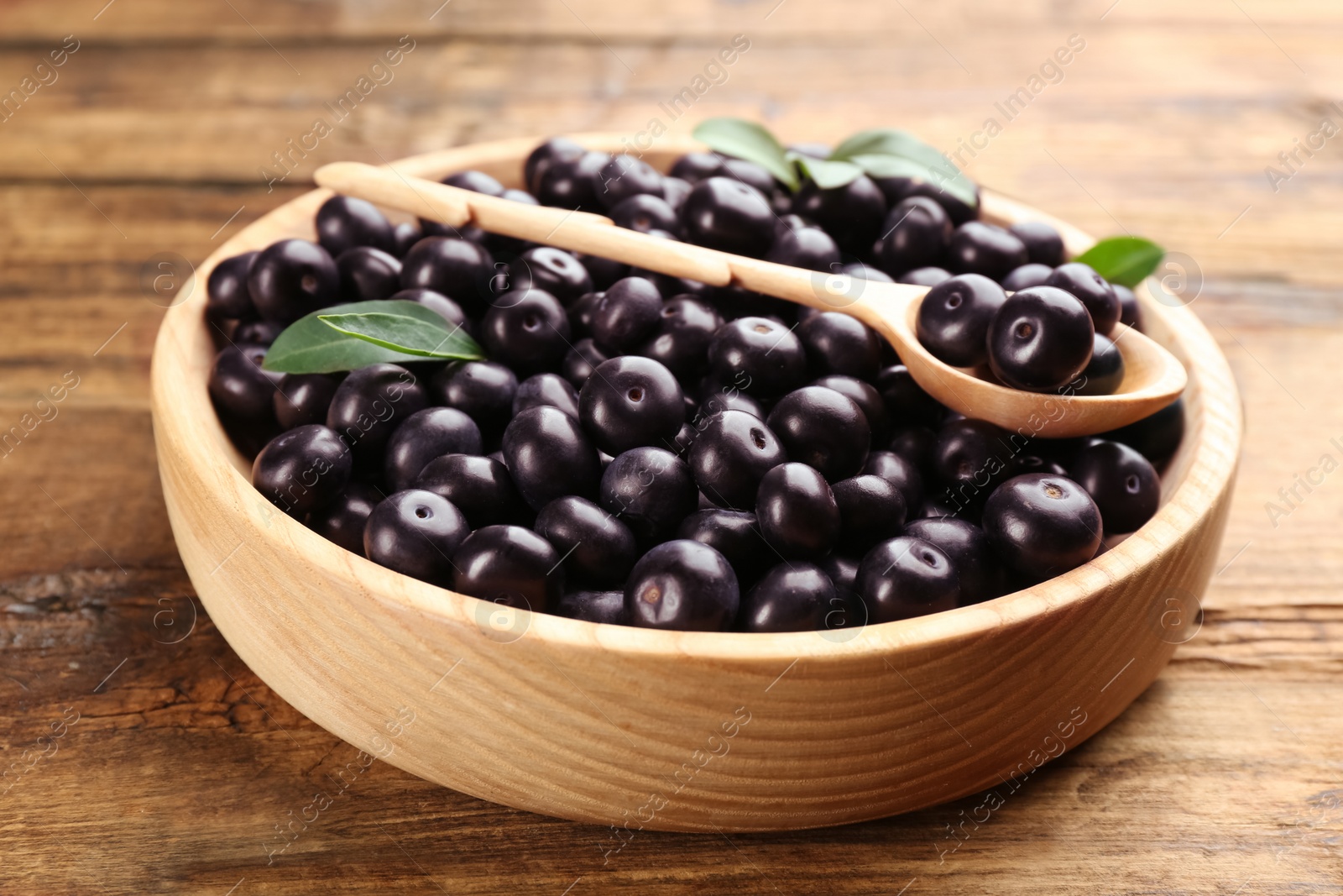 Photo of Fresh acai berries in plate on wooden table