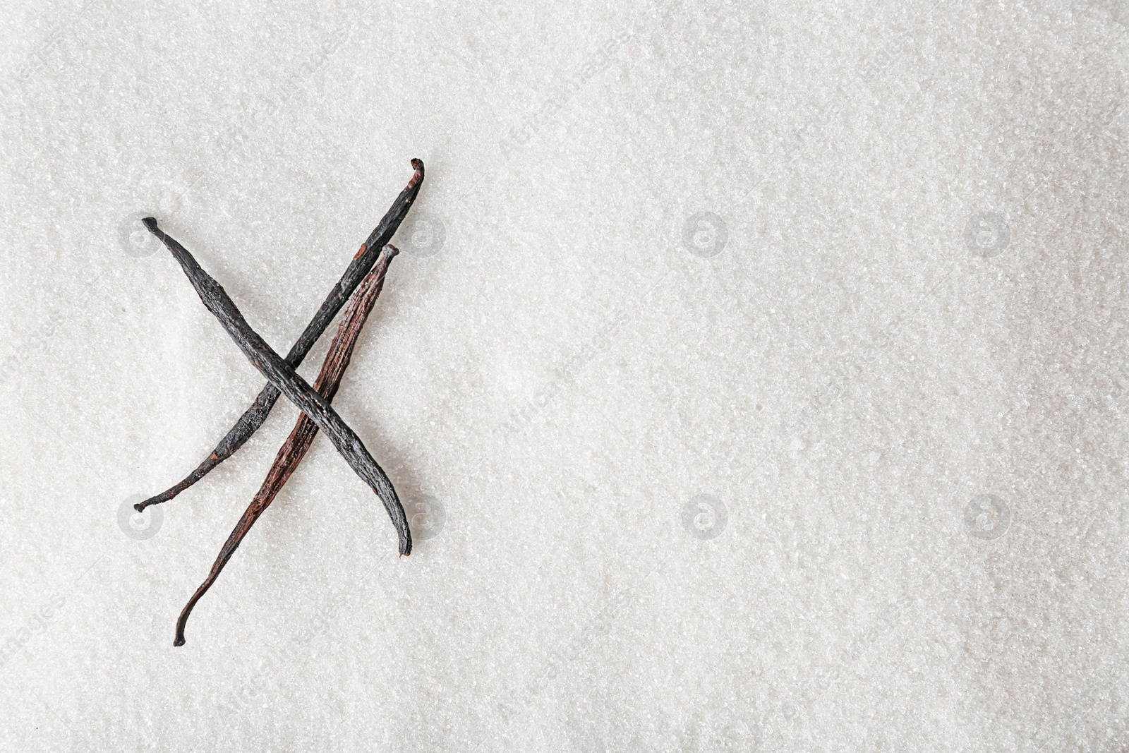 Photo of Vanilla sugar and sticks, closeup